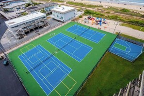 A multi-level building with a tennis court complex. - Charming beachfront resort condo w/ocean views, balcony, pools, tennis, W/D & AC (Ocean City)