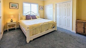A bedroom with a bed, nightstands, a window, and a wardrobe. - Spacious - Family-Friendly Beach Condo w/Balcony, A/C, Shared Rooftop Pool & Gym (Ocean City)
