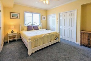 A bedroom with a bed, nightstands, a window, and a wardrobe. - Spacious - Family-Friendly Beach Condo w/Balcony, A/C, Shared Rooftop Pool & Gym (Ocean City)