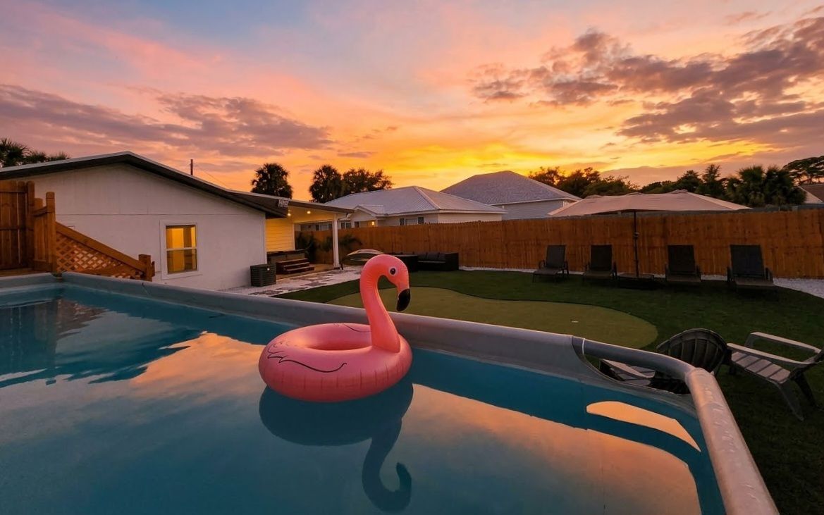 Private sunset pool oasis with lounge chairs and a fun flamingo float