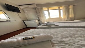 A hotel room with two beds, a TV mounted on the wall, a refrigerator, and a window with curtains. - CARDOSO PALACE HOTEL RIO VERDE (Rio Verde)