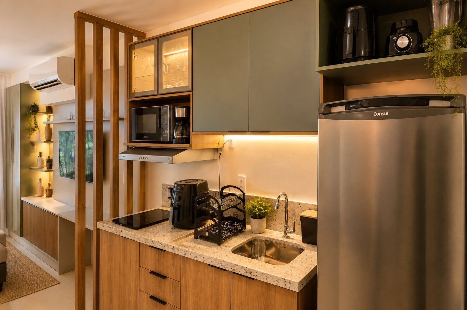 A modern kitchen with a built-in microwave, coffee maker, and a stainless steel refrigerator.