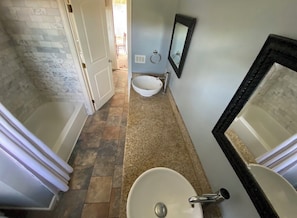 A bathroom with a white sink, a mirror, and a bathtub. - Hilltop Haven.  Private 3-bedroom house in vibrant Los Angeles (Los Angeles)