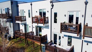 A modern apartment building with balconies, large windows, and a well-maintained exterior. - The Urban Cowboy (Nashville)
