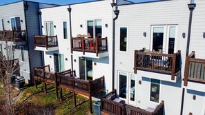 A modern apartment building with balconies, large windows, and a well-maintained exterior. - The Urban Cowboy (Nashville)