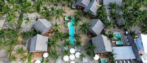 On the beach, white sand, free beach cabanas, beach umbrellas