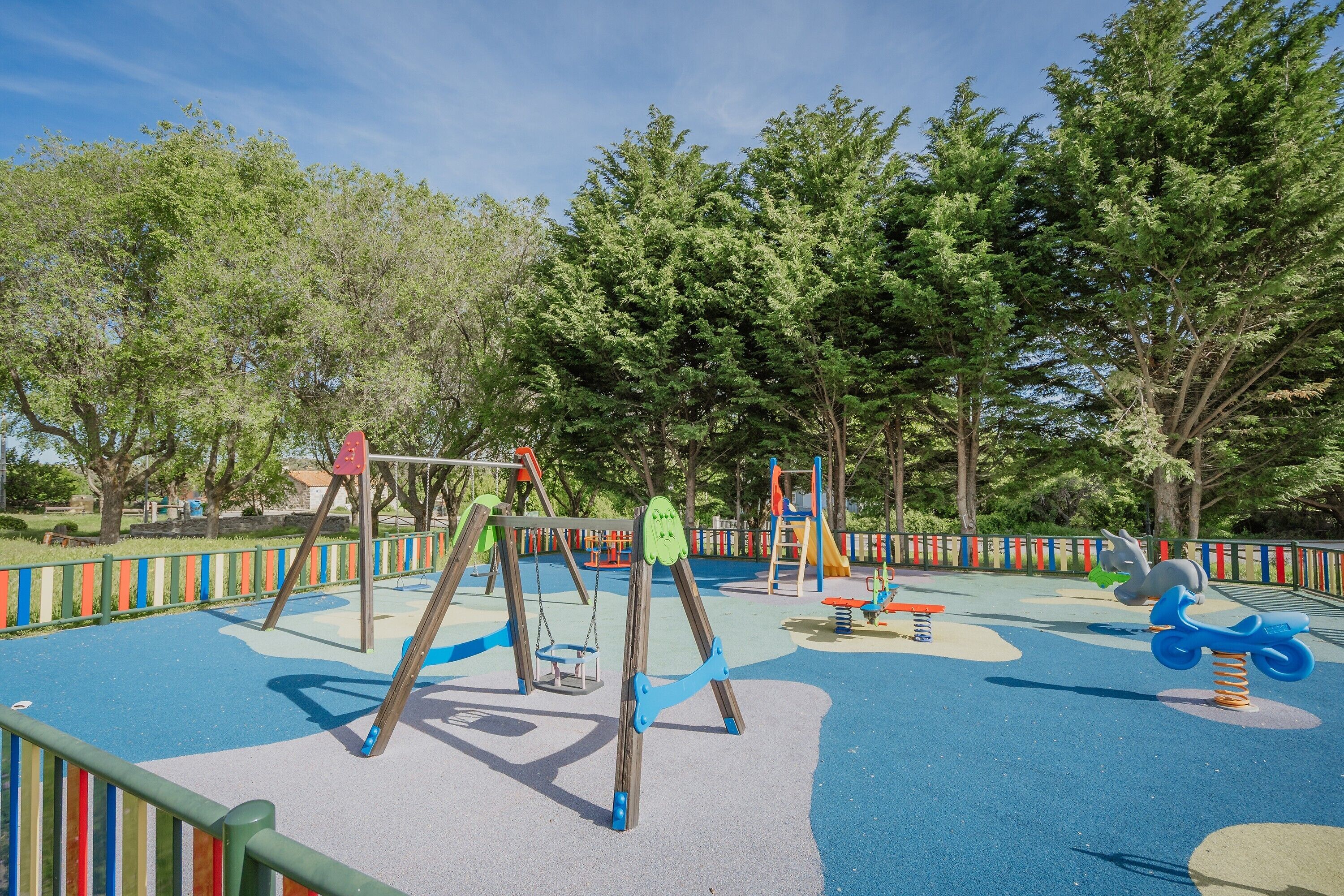 A playground with swings, slides, and climbing structures.