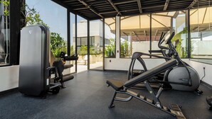 A gym with exercise equipment, large windows, and a covered area. - w* | Engaging Loft w/ Balcony in Parque Mexico (Ciudad de México)