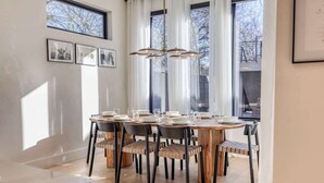 A dining area with a round table, chairs, and a chandelier. - Amenities! Pool, Hot Tub, Theater, Outdoor kitchen (Austin)