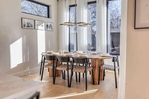 A dining area with a round table, chairs, and a chandelier. - Amenities! Pool, Hot Tub, Theater, Outdoor kitchen (Austin)