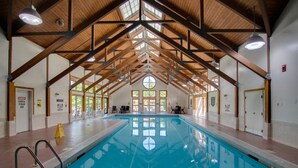 An indoor swimming pool with a high wooden ceiling and large windows. - Deer Park End Unit with Lake Access (Woodstock)