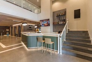 A modern bar area with a counter, two chairs, and a staircase leading to an upper level. - #TR809 | Cyclinn Faria Lima Itaim (Itaim Bibi)