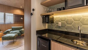 A modern kitchen with a built-in microwave, a sink, and a compact refrigerator. - Cyclinn a 400m do WTC Berrini Vila Olímpia #WB1403 (Berrini)