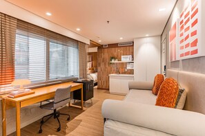 Ein modernes Schlafzimmer mit einem Bett, einem Nachttisch und einem Schreibtisch mit Stuhl.