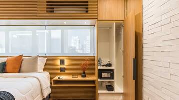 A modern bedroom with a bed, bedside table, and a wardrobe with a mirror.
