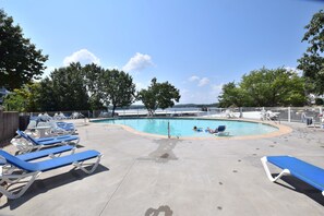 A pool area with lounge chairs and a swimming pool. - Total Consciousness 
30 Ft from Water Open Main Channel Views  3BR/3BA (Village of Four Seasons)