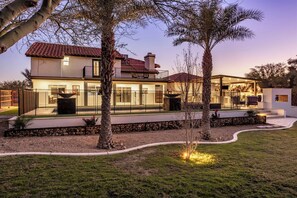 A modern two-story house with a patio, a swimming pool, and a well-maintained garden. - Mountain View Retreat (Scottsdale)