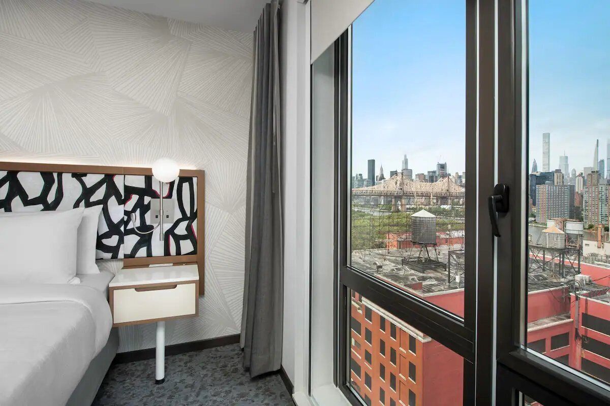 Wake up to skyline views framed by floor-to-ceiling windows.