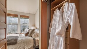 A bedroom with a bed, a window, and a wardrobe with robes. - VIP Palisades Condo A+ Location Views Hot-Tub (Olympic Valley)