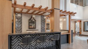 A modern bar area with a black and white chevron pattern, wooden beams, and a large mirror. - VIP Palisades Condo A+ Location Views Hot-Tub (Olympic Valley)