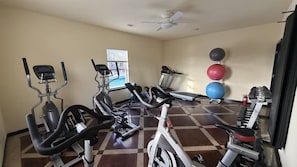 A gym with cardio machines, a treadmill, and exercise balls. - A8 • Cozy Stay • Pool • Close to A-State & Dining (Jonesboro)