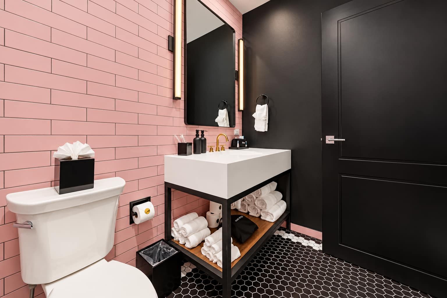 Un baño moderno con inodoro, lavamanos y toallero.