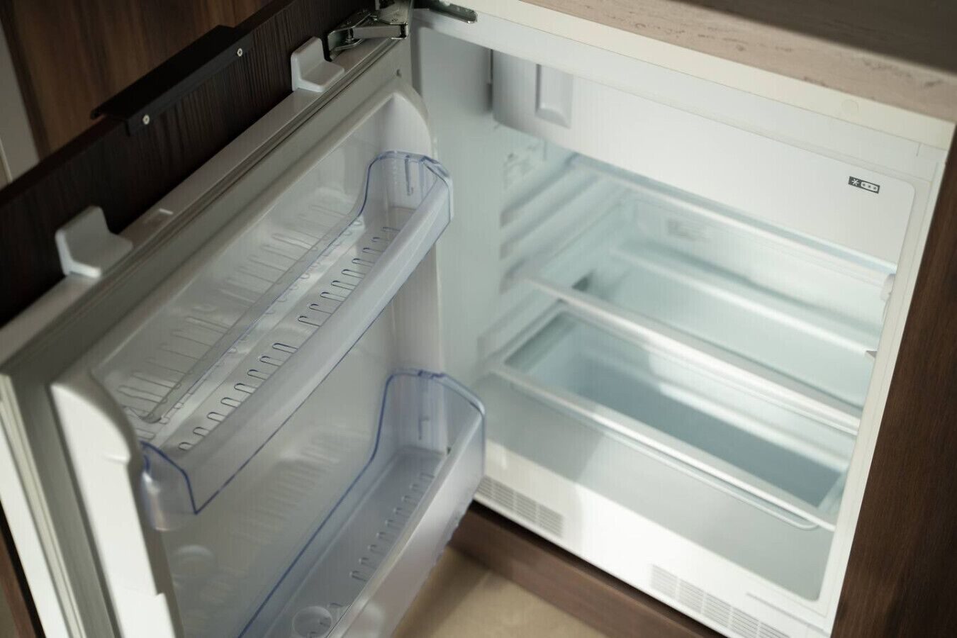A refrigerator with a freezer compartment on top and a main compartment below.