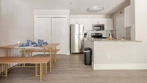 A modern kitchen with a refrigerator, microwave, stove, and sink. - Fruity King 1BR facing NRG |near Med Center | Pool (Houston)