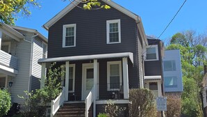 A two-story house with a porch, a staircase, and a 'PRIVATE TOW AWAY ZONE' sign.