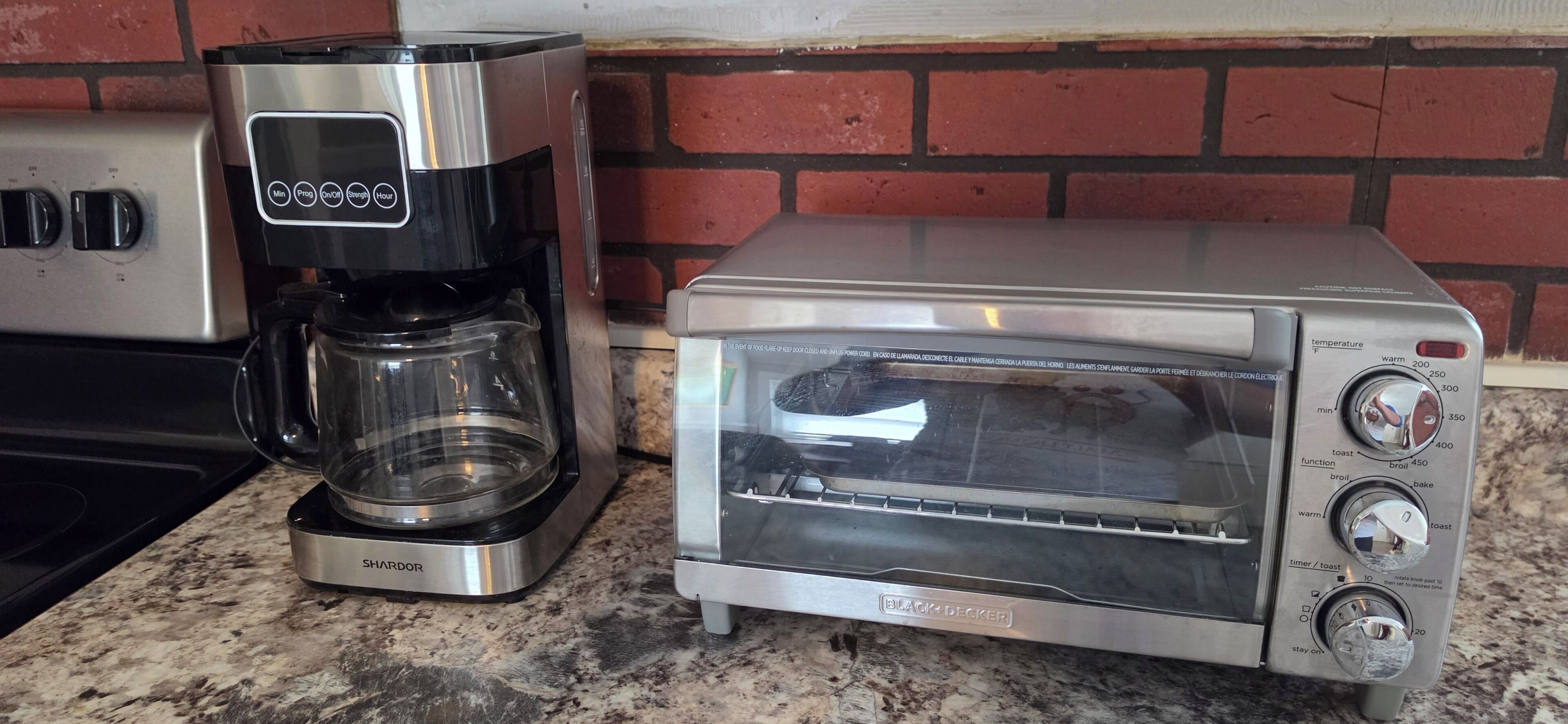 A kitchen with a coffee maker and a toaster oven.