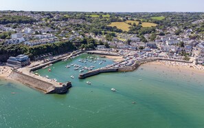 An aerial view of a coastal town with a marina, sandy beach, and residential buildings. - Fern Hill - Close to Village and Beach (Saundersfoot)