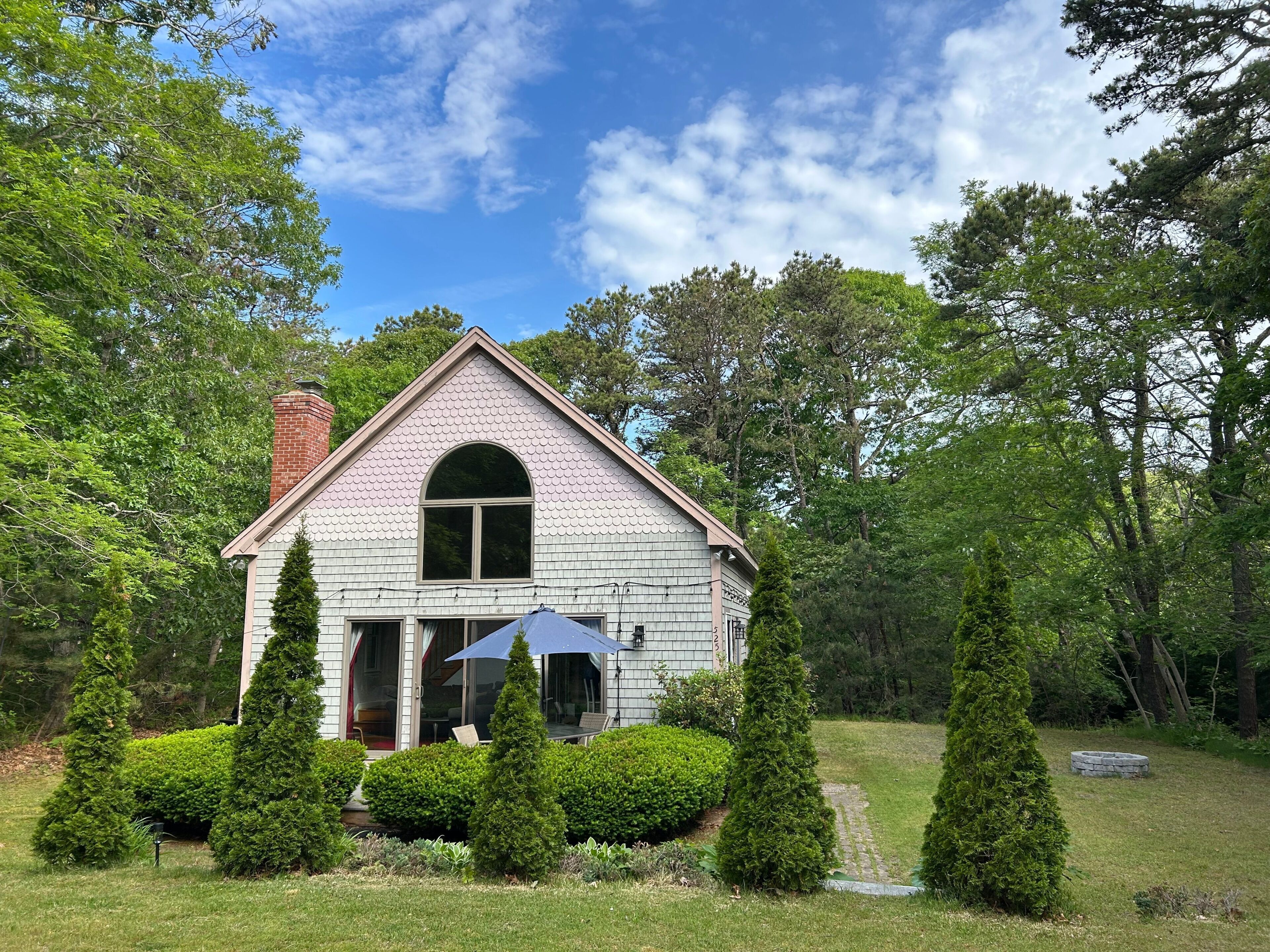 A house with a gabled roof, a chimney, and a front door.