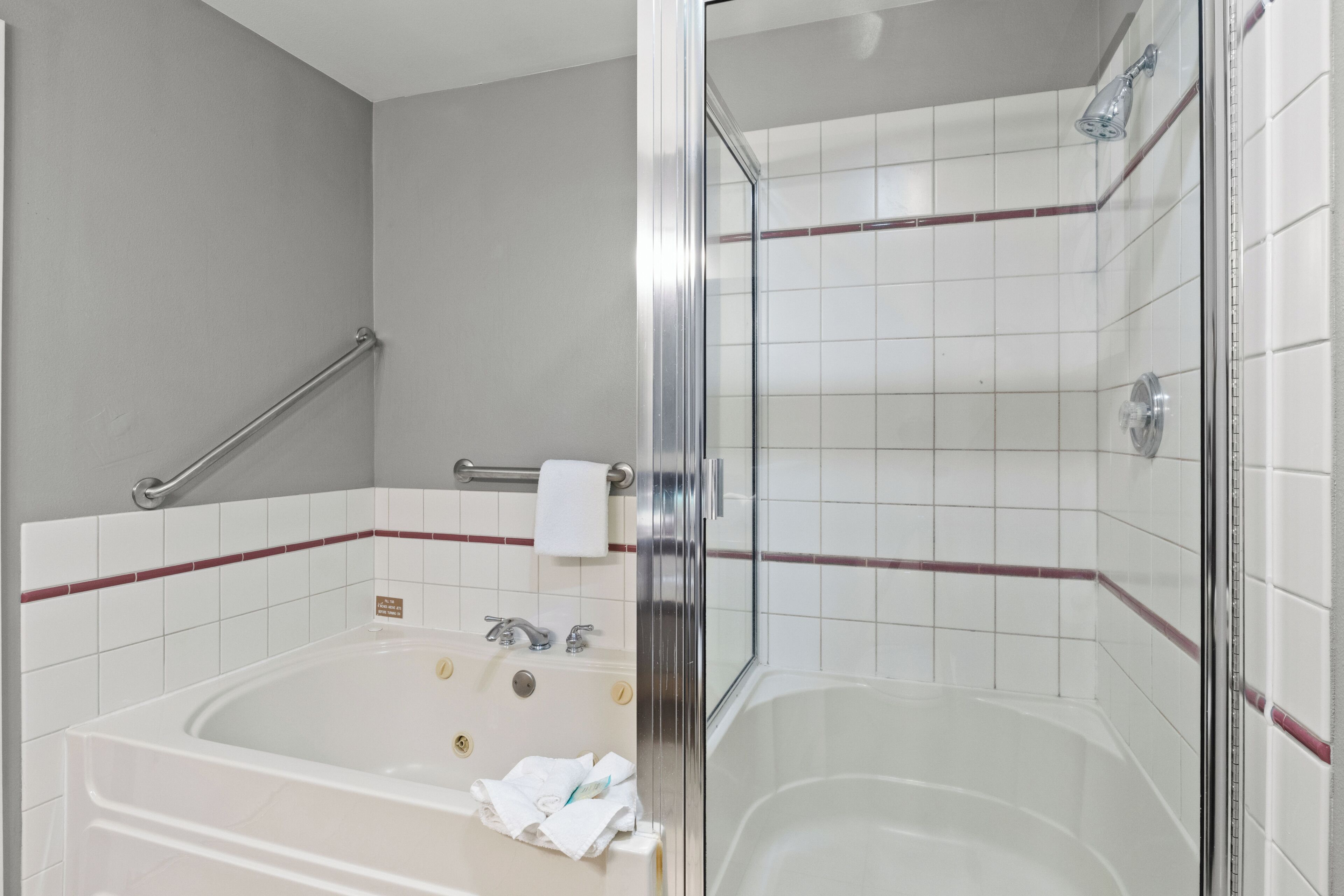 Separate bathtub and shower, hair dryer, towels, soap