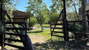 A wooden gate with a sign reading 'Welcome to the Ranch.'