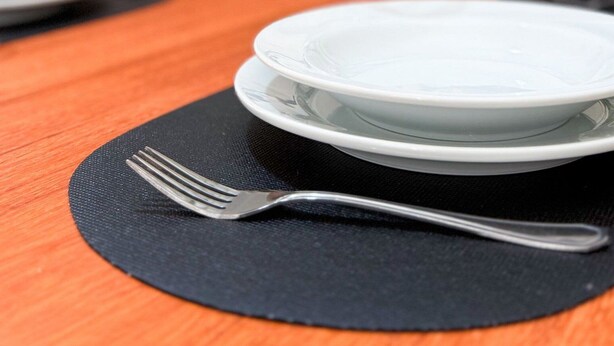 A dining table with plates, cutlery, and a placemat. - Stay House - Pousada boutique (Joinville)