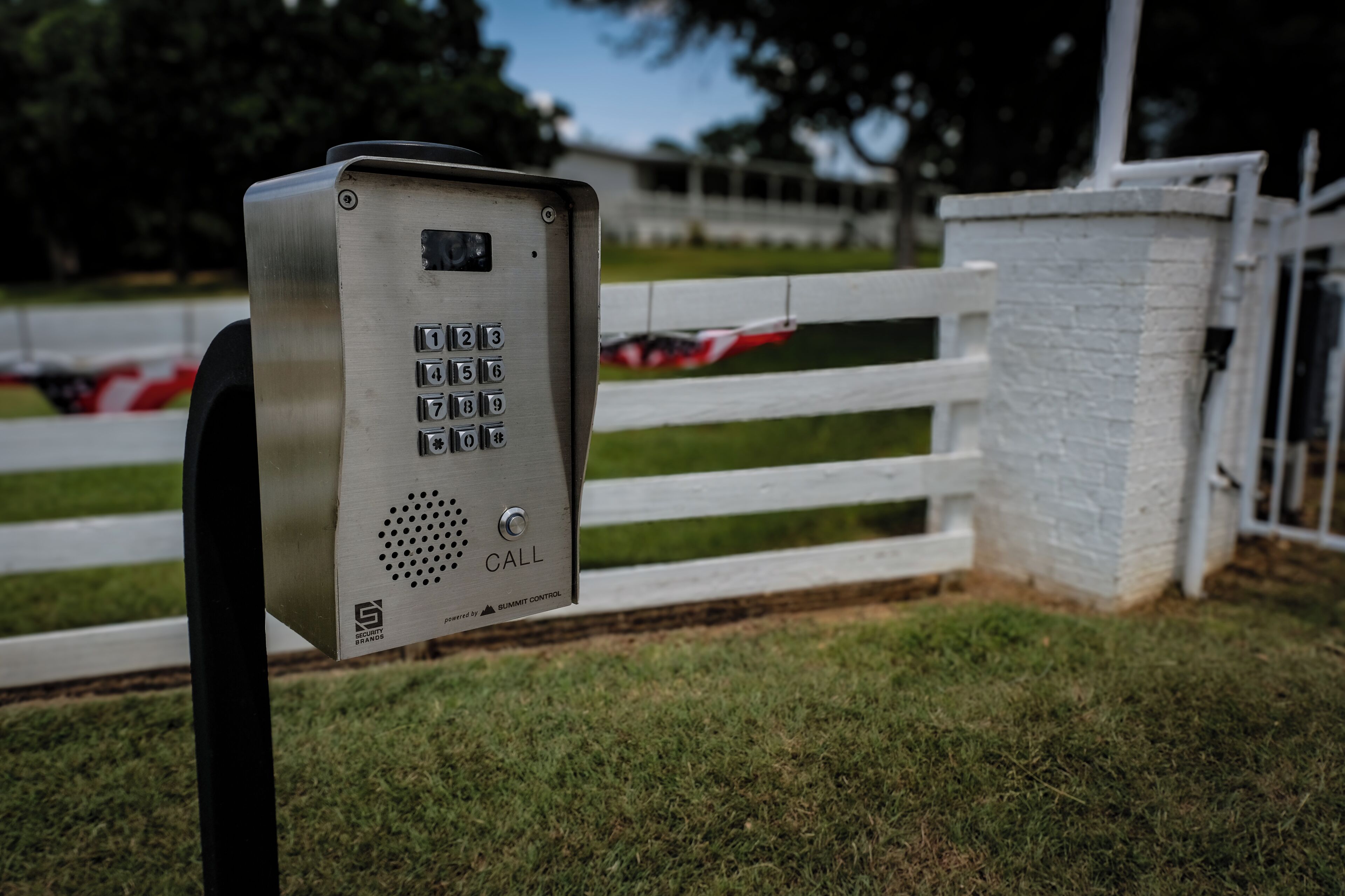 A metal security keypad with a 'CALL' button, mounted on a post.