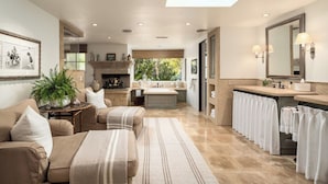 A spacious bathroom with a large mirror, a bathtub, and a sink. - Gated 7BR Rancho Santa Fe Estate Pool/Guest House (Rancho Santa Fe)