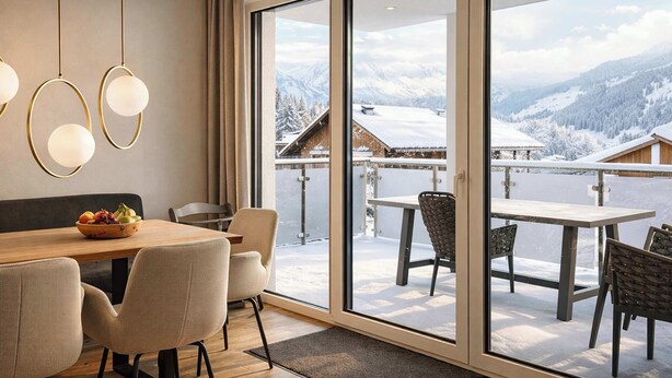 A dining area with a wooden table, chairs, and a bowl of fruit. - ZILLER DELIGHT – Stylish Apartment with Balcony & Mountain View (Fügen)