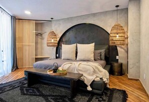 A modern bedroom with a bed, bedside tables, a hanging light fixture, and a window with curtains. - Beautiful Curated and Designed Flat plus Great Balcony (Mexico City)