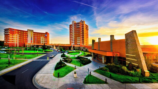 A hotel with a central courtyard, multiple buildings, and a clear sky.