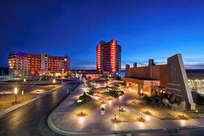 A hotel with multiple floors, a parking area, and landscaped gardens. - Downstream Casino Resort (Quapaw)