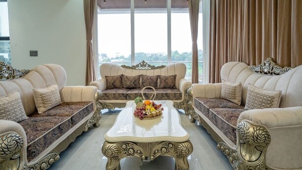A living room with two sofas, a coffee table, and a window with curtains. - Enjoy your staycation in lonavala with our luxurious villa. (Lonavala)
