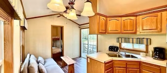 Cozy 2-bedroom cabin with AC. Fun for all ages with pond and pool access. 
