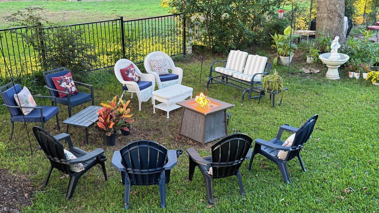 An outdoor seating area with various chairs and a fire pit.