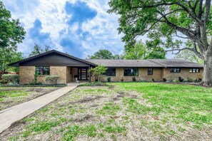 Charming single-story home with modern updates, mature trees, and a welcoming front entry. - Walk to Square | Backyard Oasis + Pool and Sauna (Georgetown)