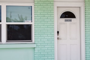 Exterior view showing a window and a white door labeled Laundry Room.