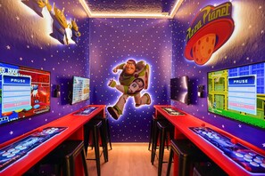 A room with a space-themed design, including a large window, a wall with a space-themed mural, and a pizza-themed sign. - 8 BD / 6 BA / Windsor Cay 16095 CL (Clermont)