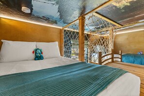 A room with a bed, a netted window, and a view of the outdoors. - 10 BD/ 8 BA/ Windsor Cay (1003 CR) (Clermont)
