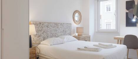 Desk, iron/ironing board, bed sheets
