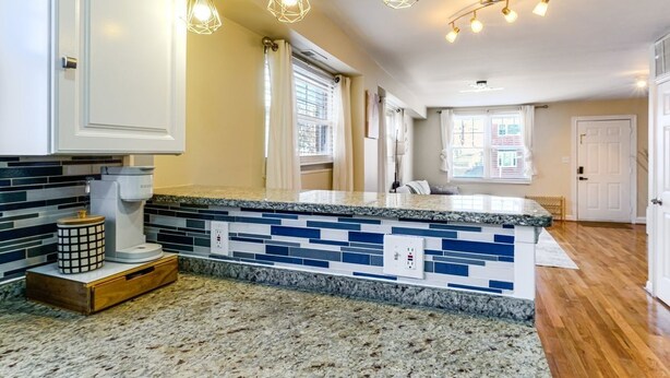 A kitchen with a granite countertop, a coffee maker, and pendant lighting. - 3BR Near Takoma Metro & DC Hospitals (Washington)